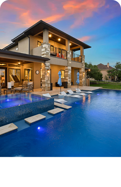 Luxury Pools design. A backyard featuring a pool and patio area.