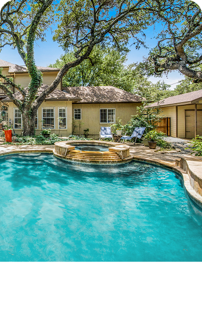 An inviting backyard with a pool and patio area.